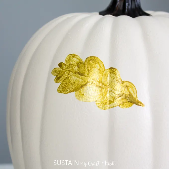 Close up on white pumpkin and full finished gold leaf.
