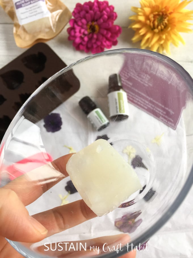 Block of unmelted glycerin soap with aloe in a clear glass bowl.