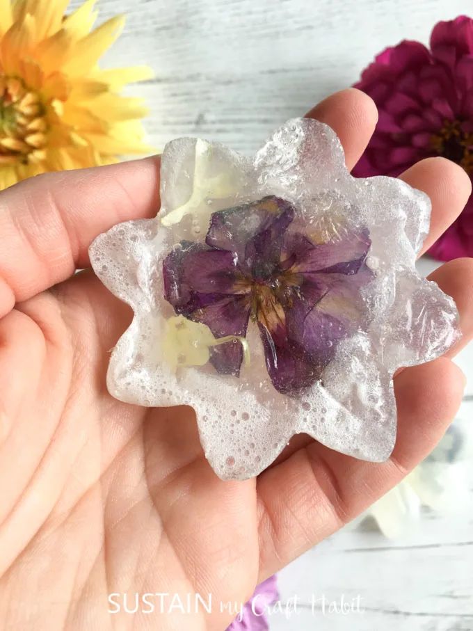 A close up image of flower petals embedded in the completed glycerin soap.