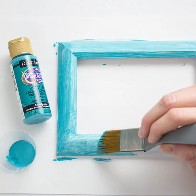 Painting a photo frame turquoise.