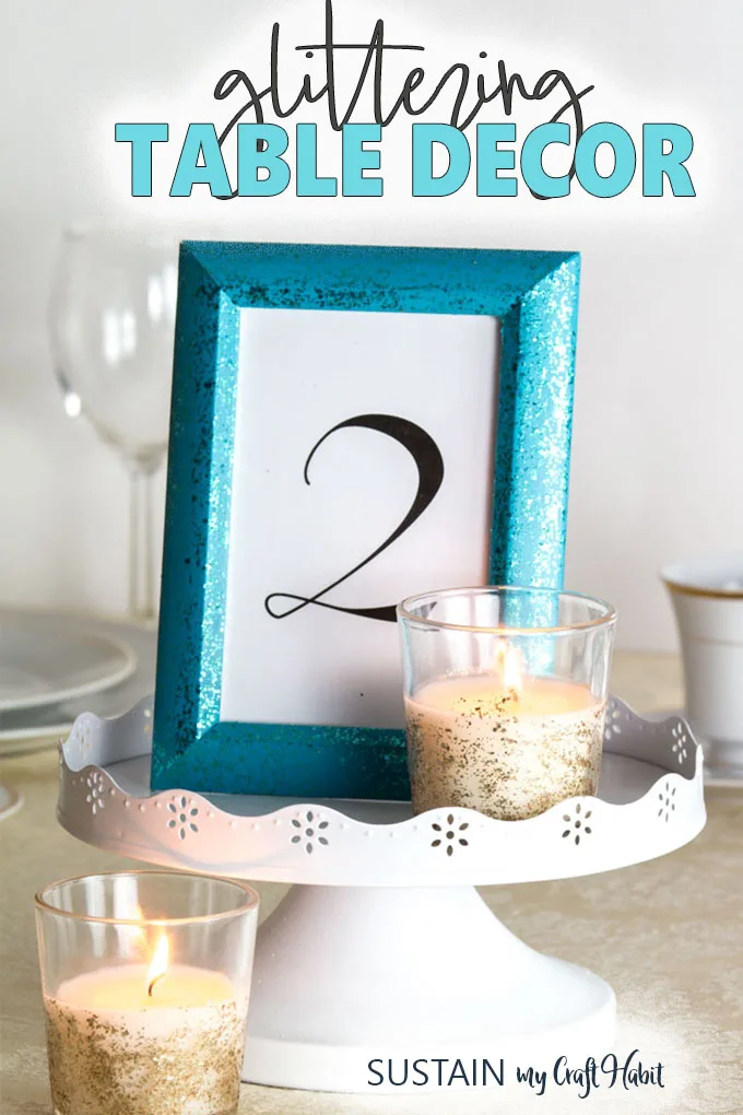 Elegant DIY wedding table decorations including a turquoise glittering frame and golden votive candle on a white pedestal. 