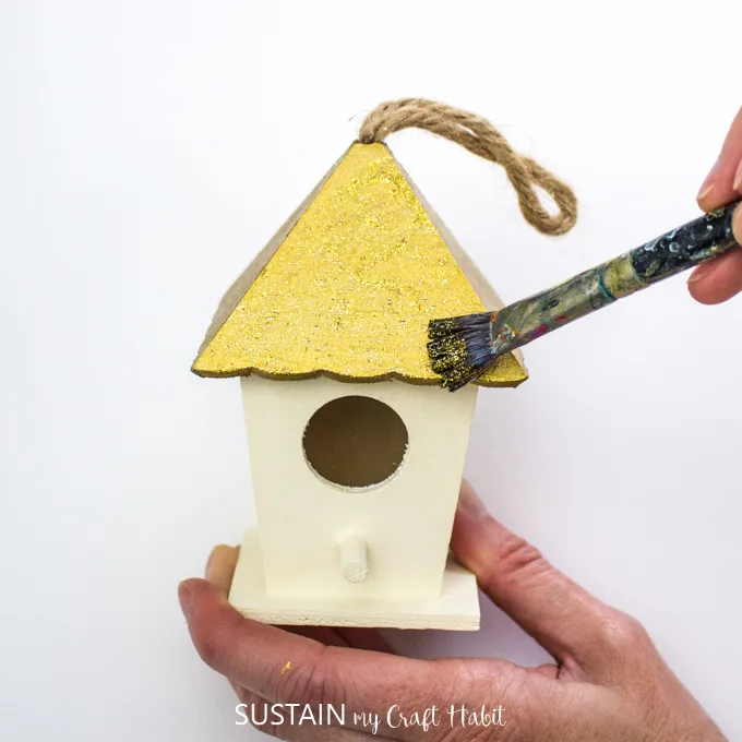 Example of painting gold on to the roof of one small wood birdhouse.