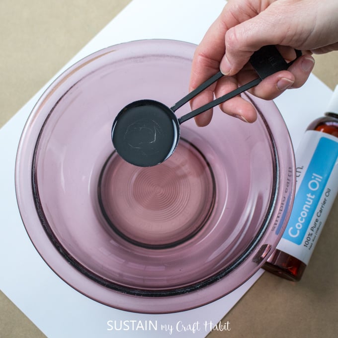 Adding liquid coconut oil to the pink glass bowl.