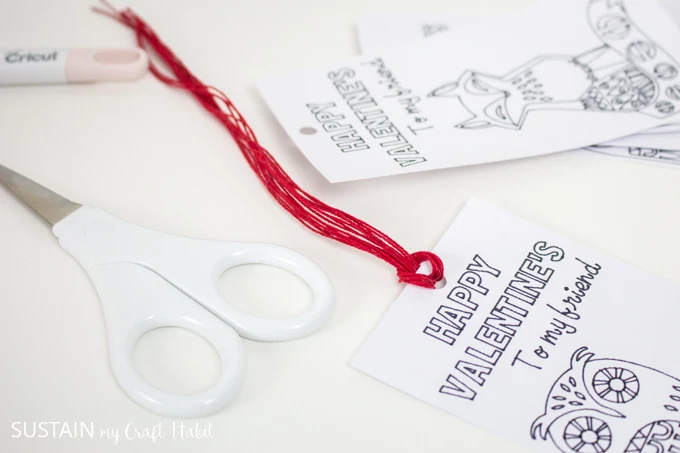 fold embroidery floss in half and loop on to bookmark to form tassels