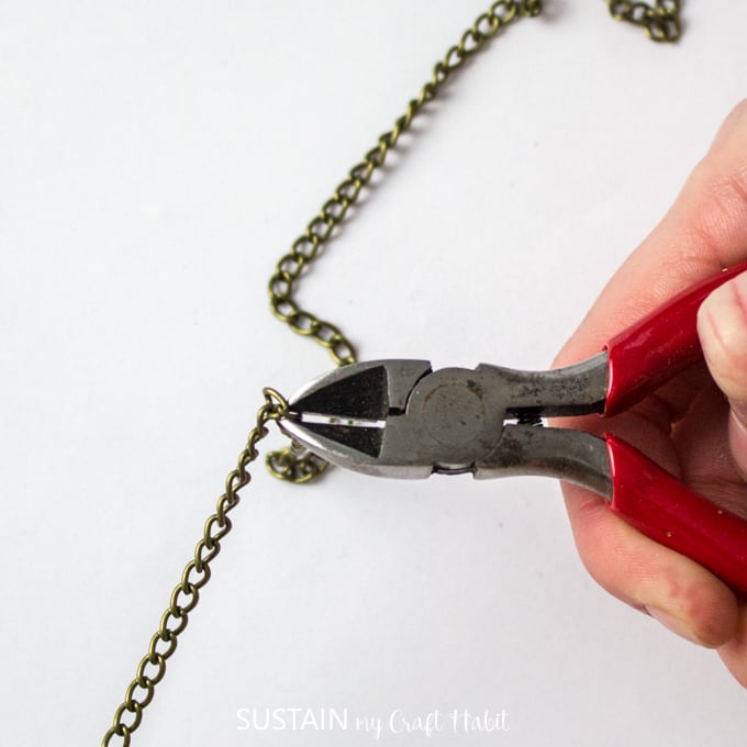 Wire cutters cutting gold jewelry chain for this handmade jewelry idea.