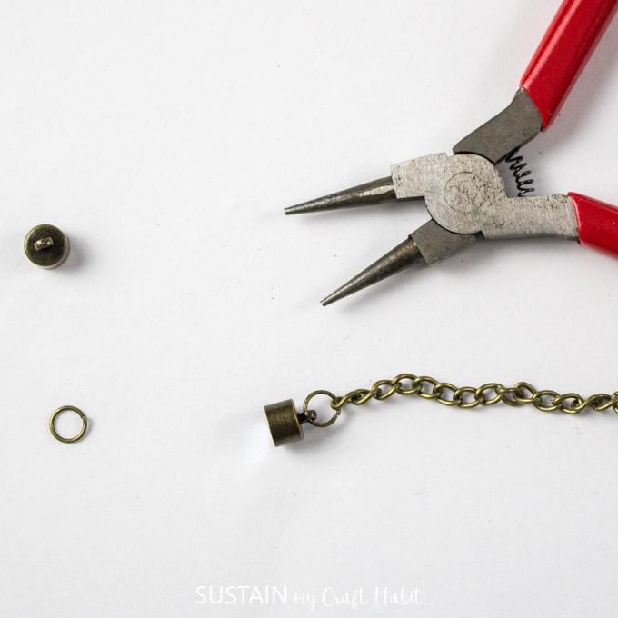 Attaching magnetic fastener to necklace link.