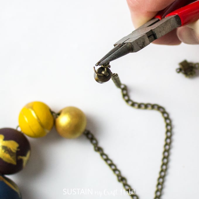 Attaching magnetic fasteners to the chain ends using necklace links and wire cutter.