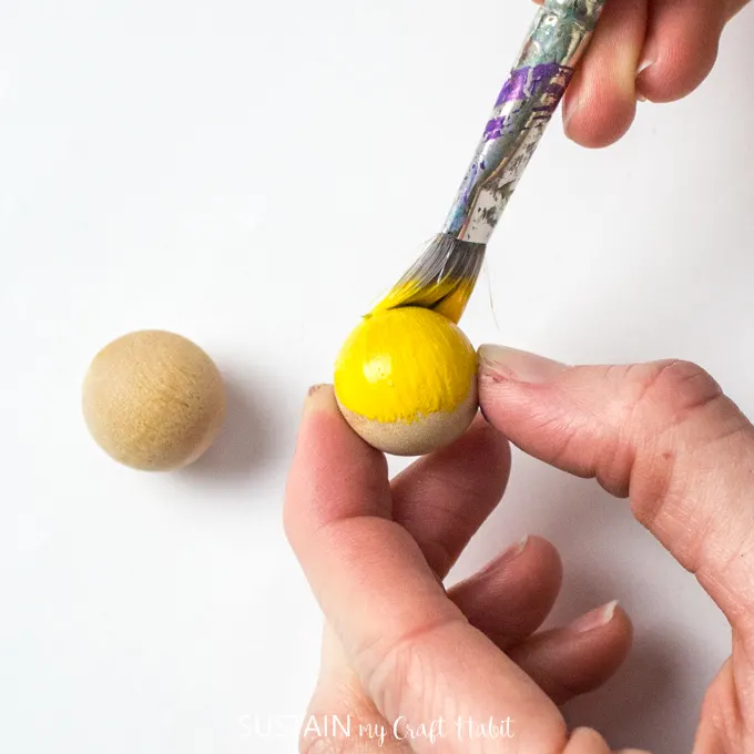 Painting a wooden bead yellow