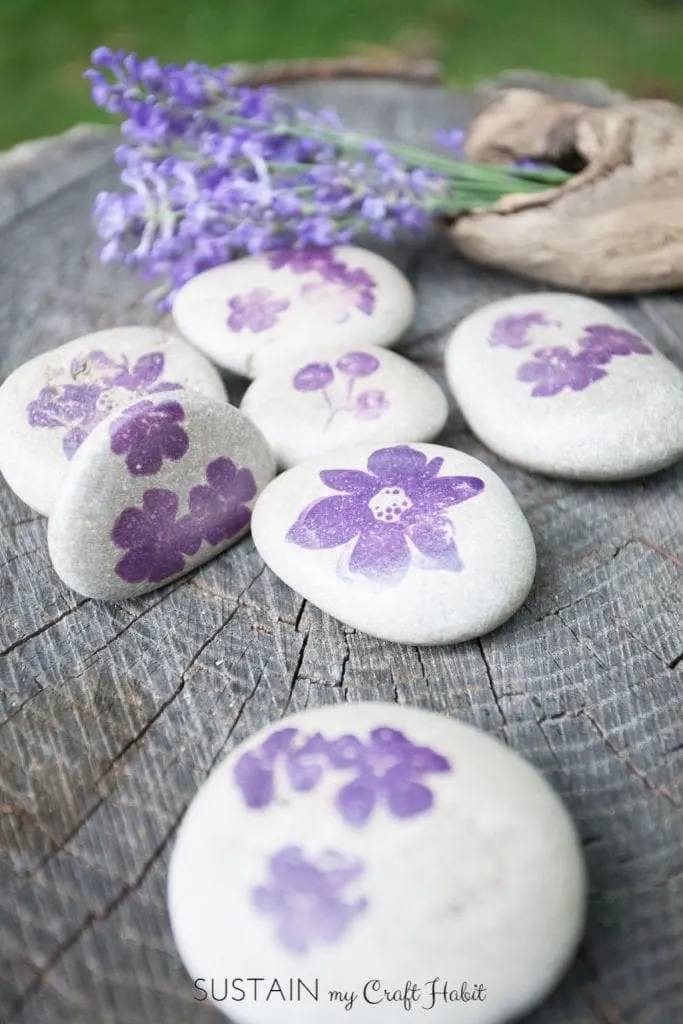 Small rocks stamped with purple flowers