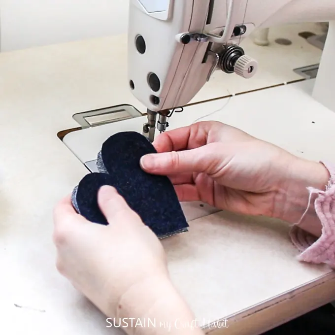 Aligning the denim fabric heart cut outs.