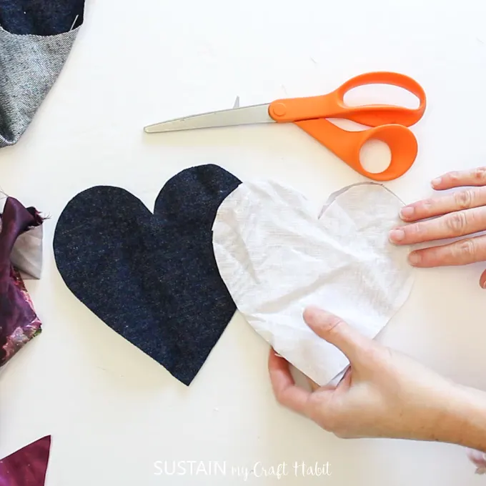 Adding a white fusing heart shape fabric to the heart shaped denim fabric.