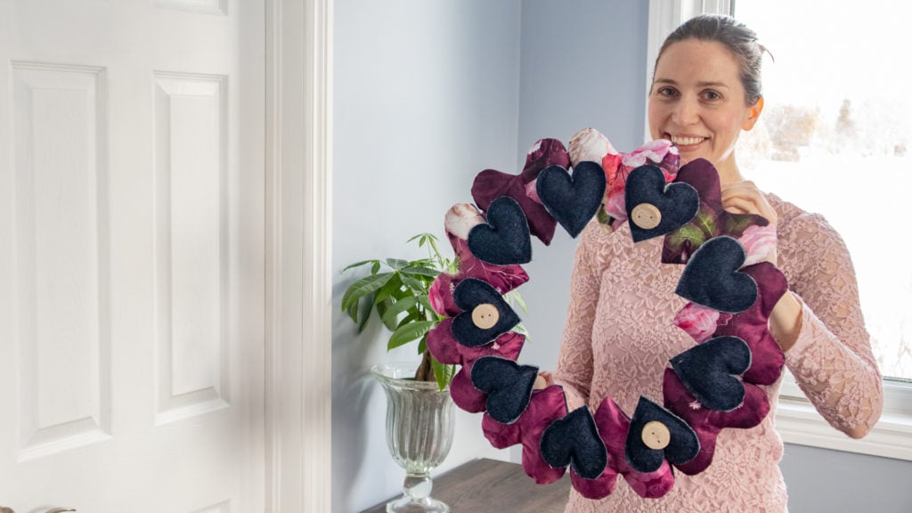 Holding the finished fabric heart wreath.