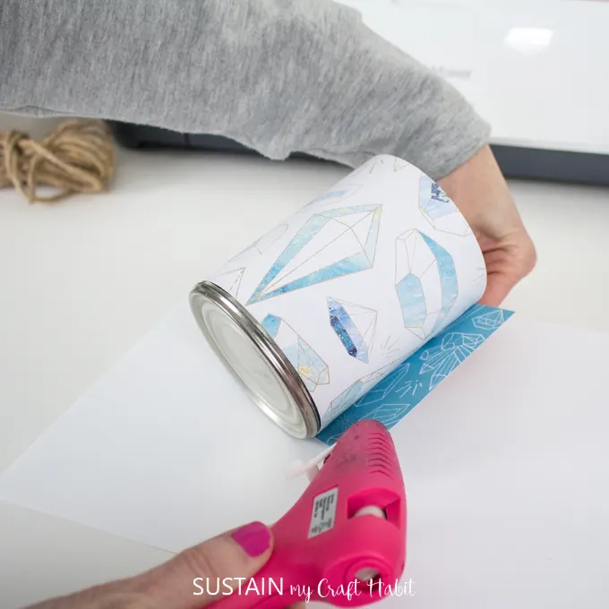 wrap and glue Cricut Deluxe paper around tin can 