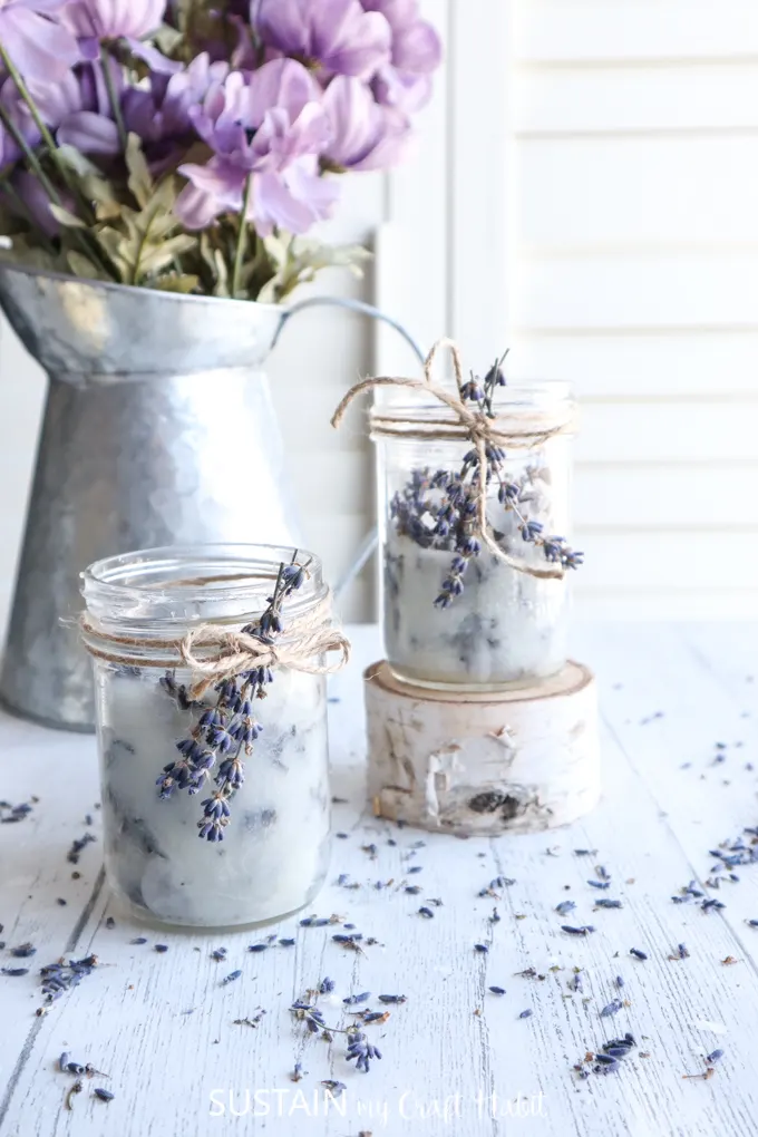 Mason jar lavender candles on a table display.