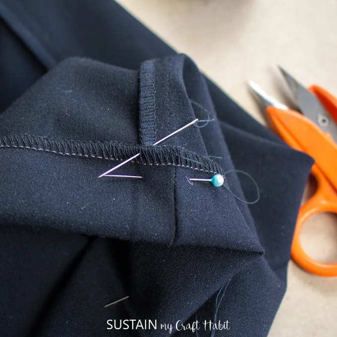 Close up view of sewing an invisible hem on a straight leg pant.