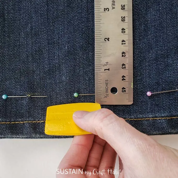 Marking a cut line for frayed hem pant.