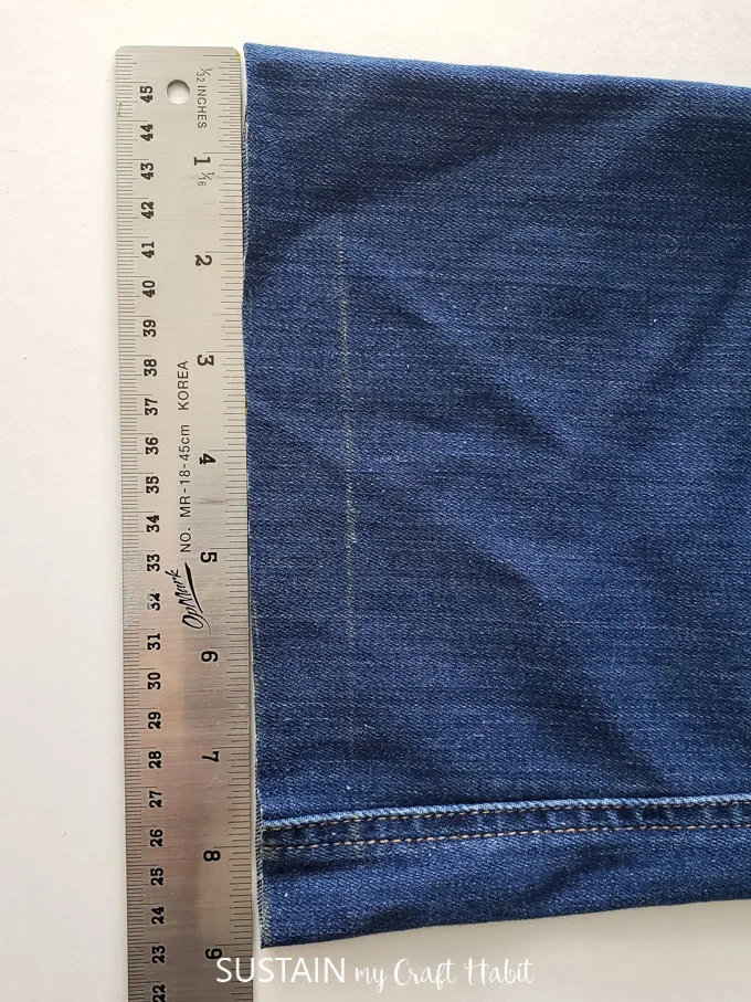 Measuring the leg opening at the new cut edge on a wide-leg pant.