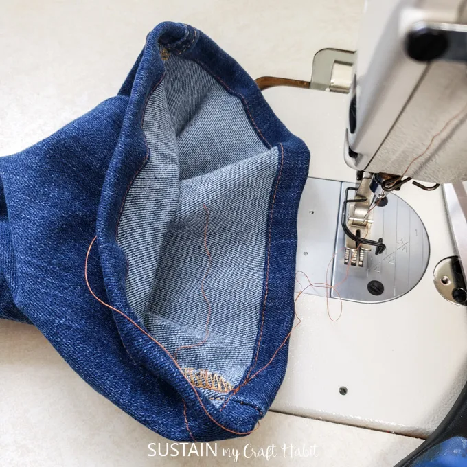 Stitching a new pant hem with a sewing machine.