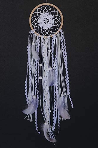 A complete dream catcher against a black background.