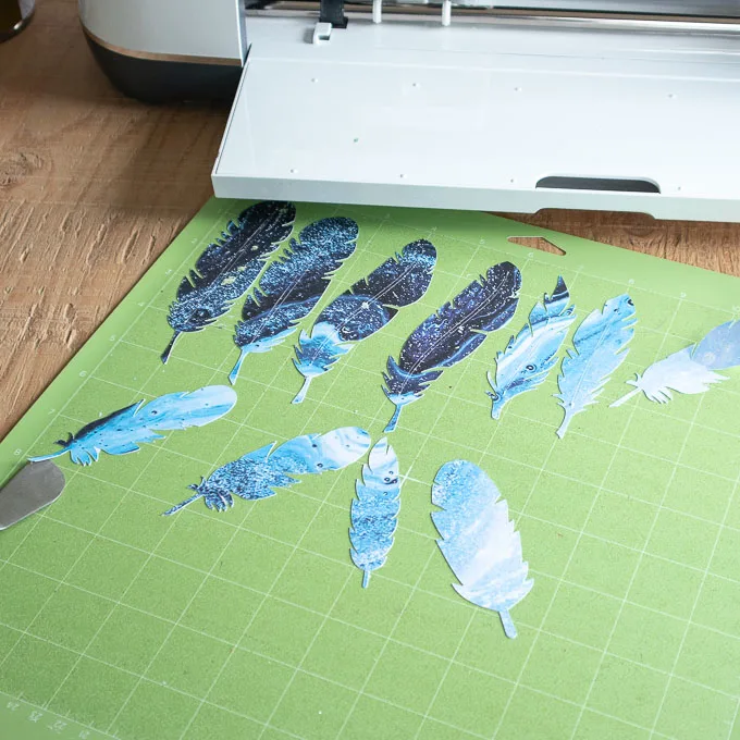 Blue paper feathers on a green grip mat.