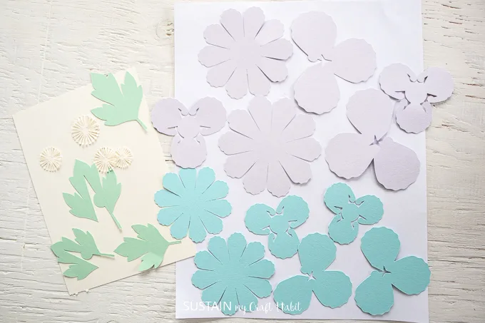 white, green, blue and purple cut out pieces.