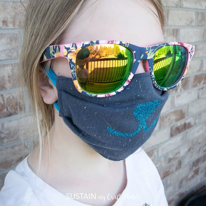 child age 8 wearing a reusable face mask made from upcycled shirts