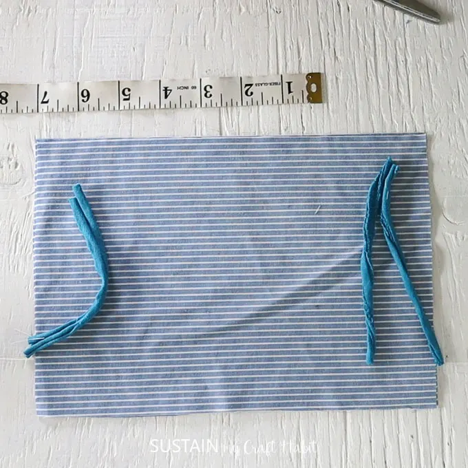 cut elastic for ear loops and position along the short ends of the rectangle piece
