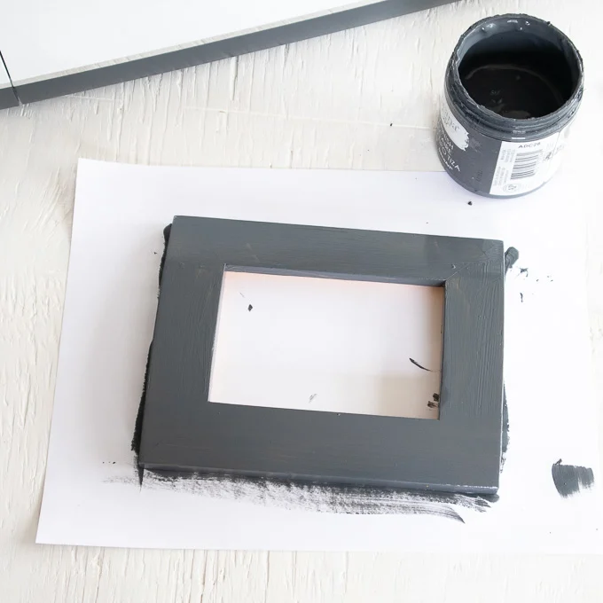 Photo frame after being painted with charcoal colored paint.