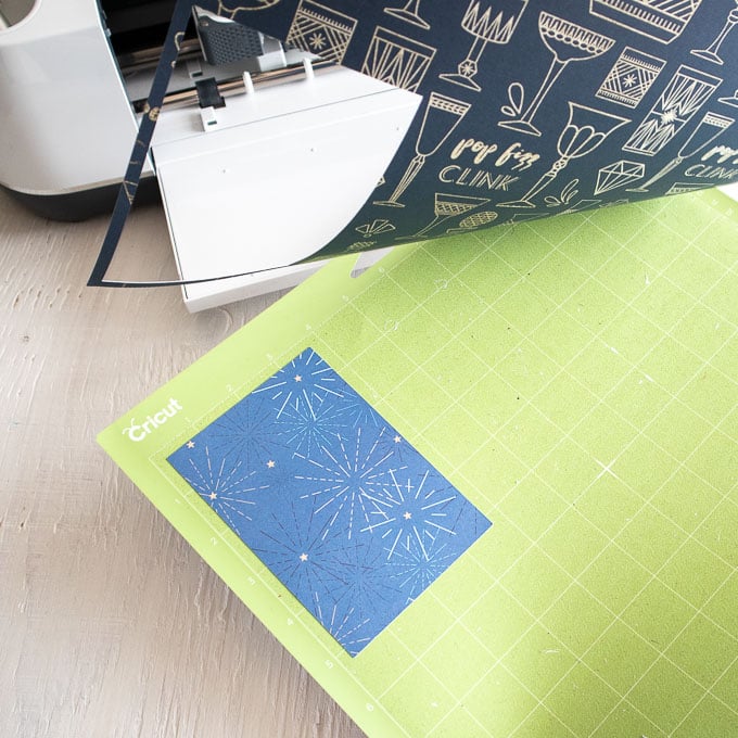 Removing the blue vinyl from the Cricut grip mat.