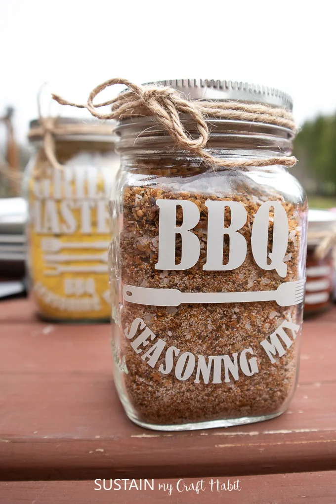 Mason jars labelled as BBQ seasoning sitting on a table.