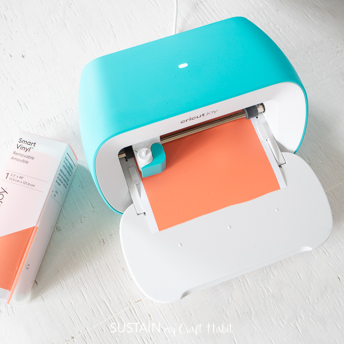 Cricut Joy cutting out the fridge drawer labels using Permanent Smart Vinyl in coral