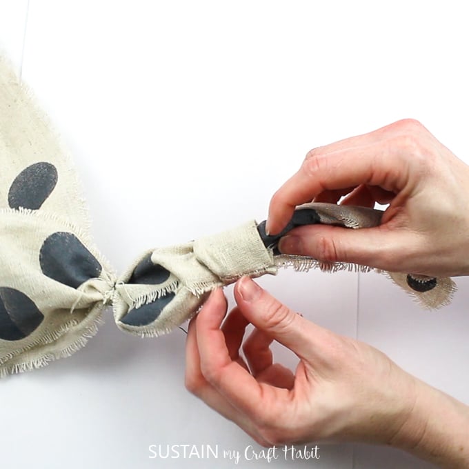 Threading the sewn loop to middle the polka dot ribbon