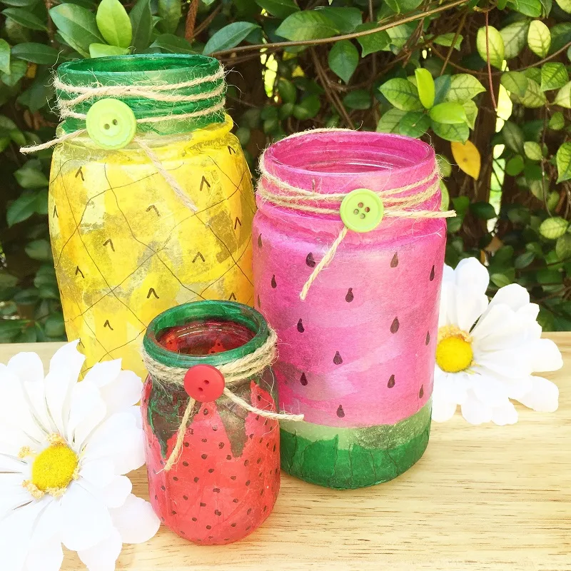 Mason jars painted to look like a strawberry, watermelon and lemon.