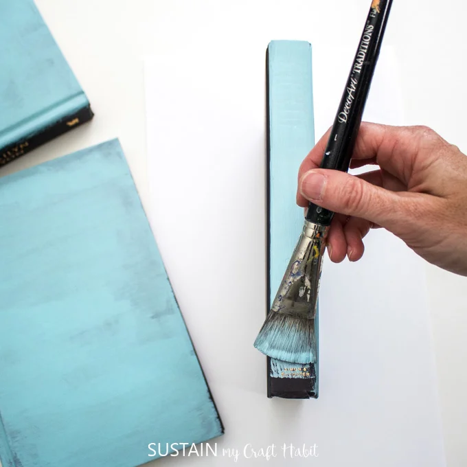 Painting the spine of the hardcover book blue.