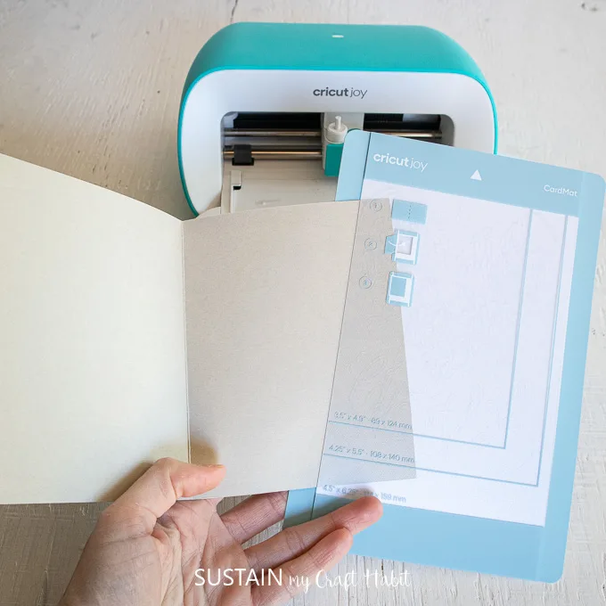 Sliding a folded card into a plastic divider. 
