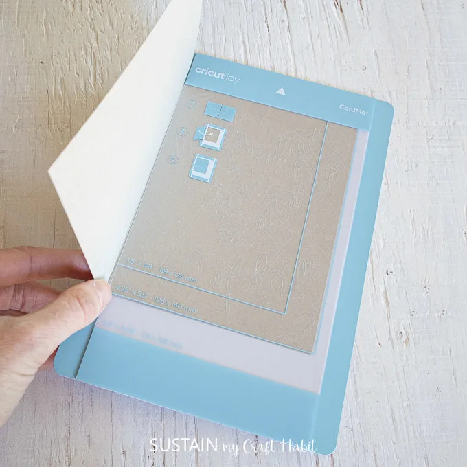 Aligning a folded card with the plastic divider.
