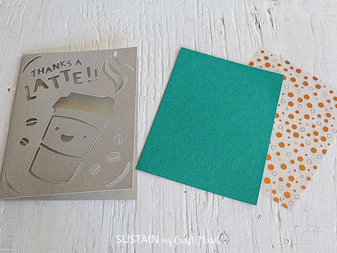 The cut out card next to a blue and polka dot insert.