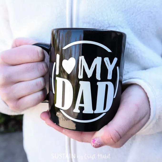 child holding a diy father's day coffee mug