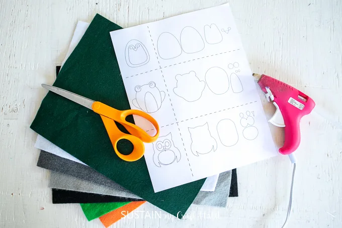 Materials needed to make these felt animals pencil toppers including felt fabric, scissors, hot glue gun and printable template.