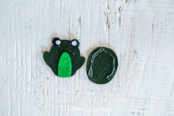 Gluing two of the green felt fabric to make a frog. 