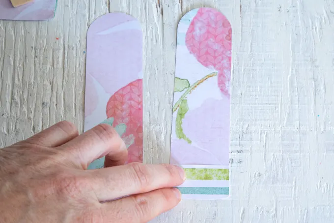 Gluing small pieces of paper onto the popsicle cut out.