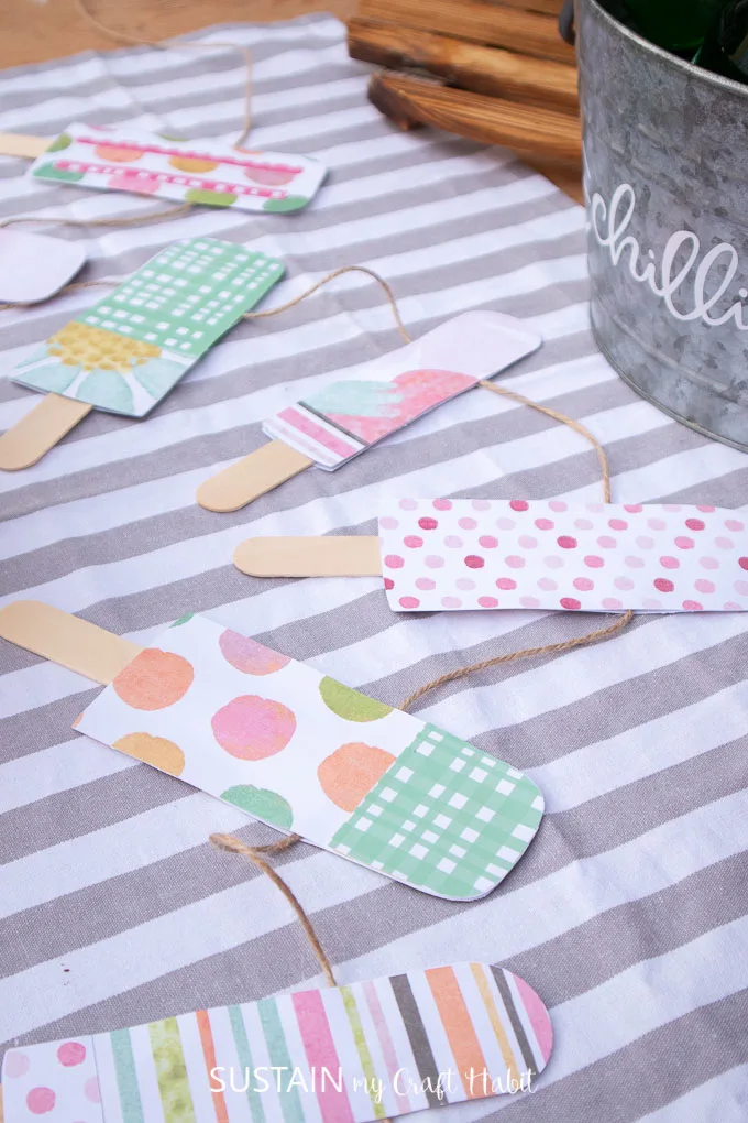 Finished colorful paper popsicle stick garland placed on a table top.