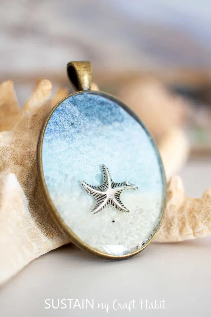 Close up of a starfish inside a seashore resin pendant.