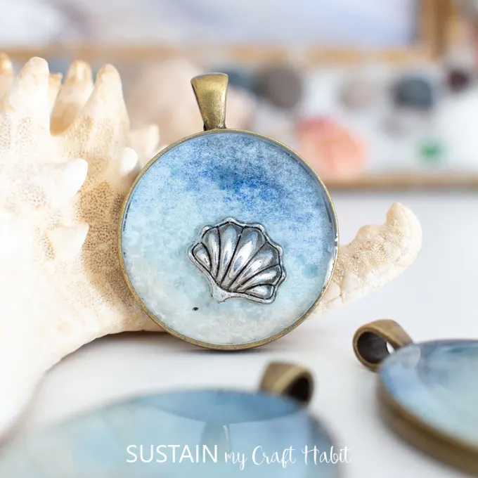 Close up of a seashell inside a seashore resin pendant.