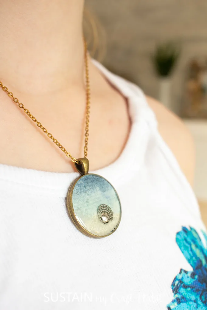 Wearing a seashore resin pendant necklace.
