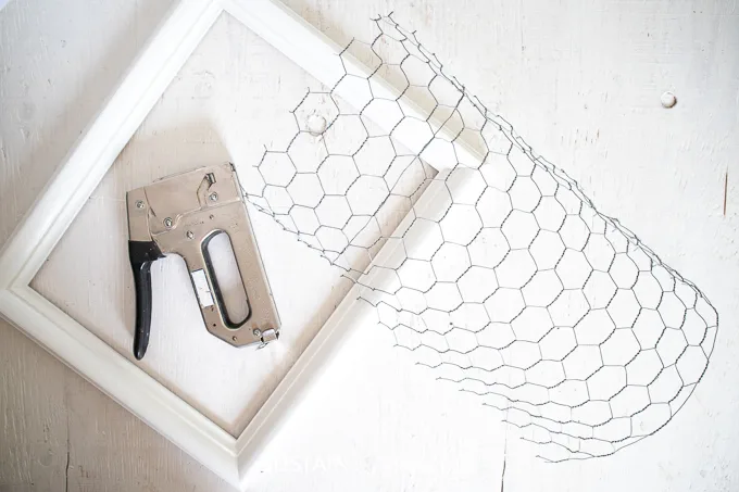 Painted picture frame, cut chicken wire and a staple gun.