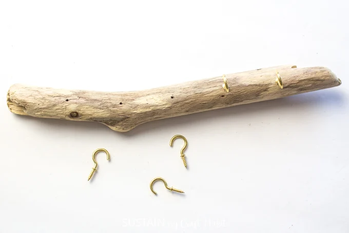 Adding 5 gold hooks to the driftwood.