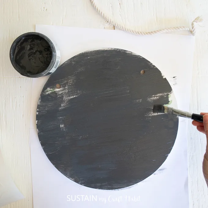 Painting a wooden sign.