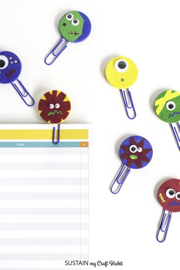 Purple paperclip bookmarks made with colorful monster shapes.