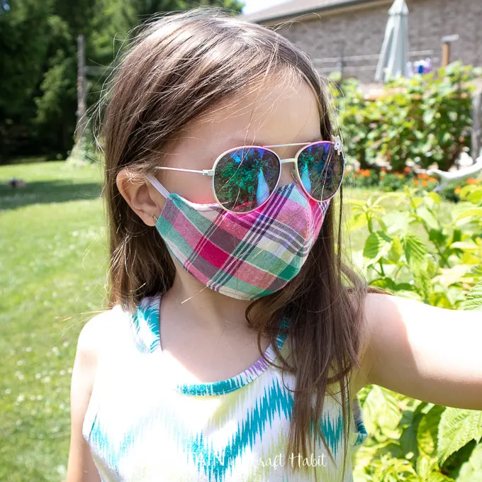 6 year old wearing fitted face mask while outside